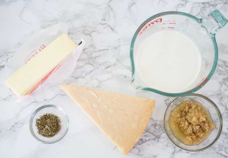butter, parmesan cheese wedge, cream in measuring cup, minced garlic Italian seasoning
