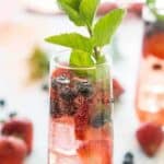 flute of berry sangria with mint sprig
