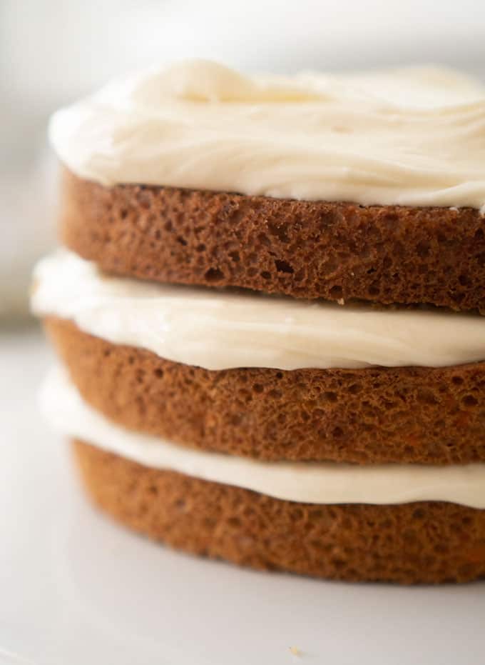 cream cheese frosting in between layers of carrot cake
