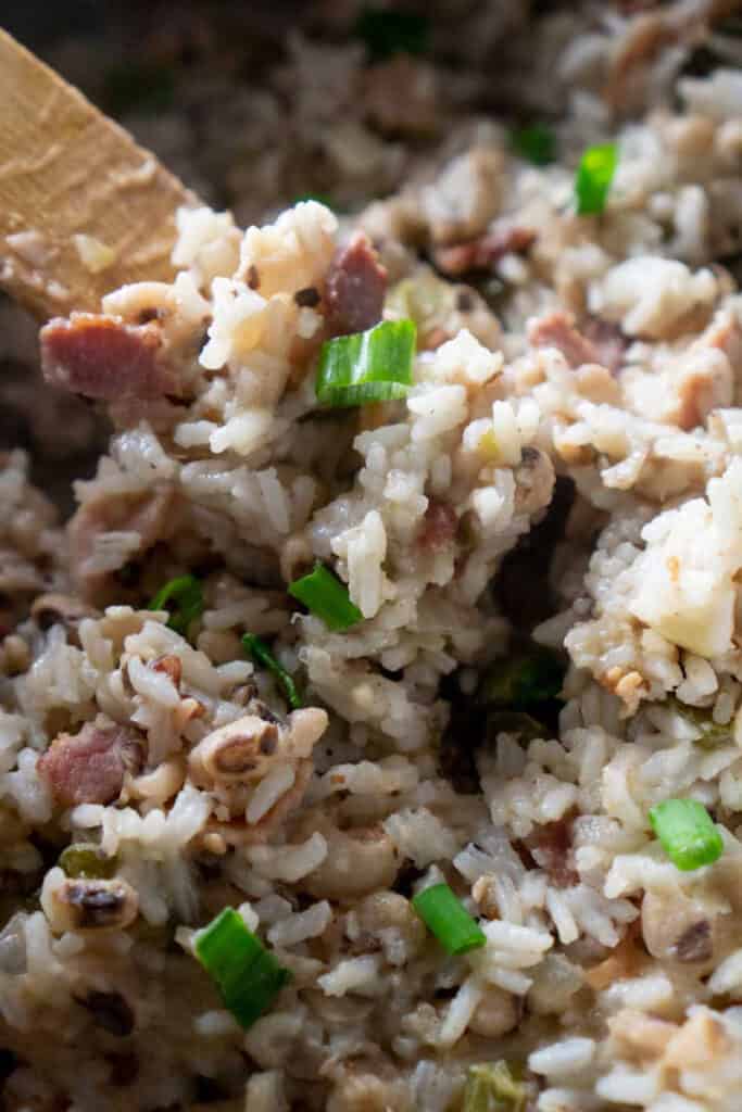A close up of hoppin john with black eyed peas and rice in pan