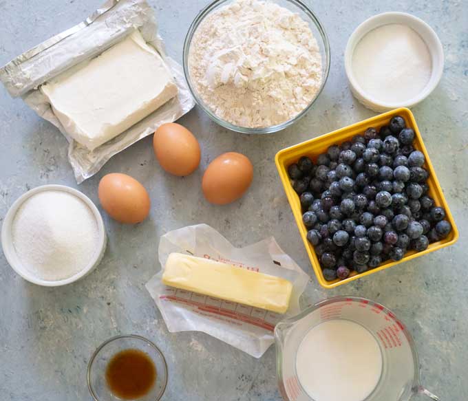 ingredients for blueberry bread on blue background