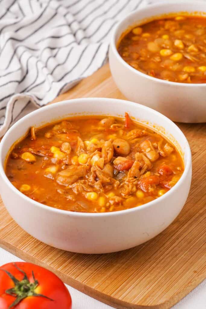 two white bowls of Brunswick stew