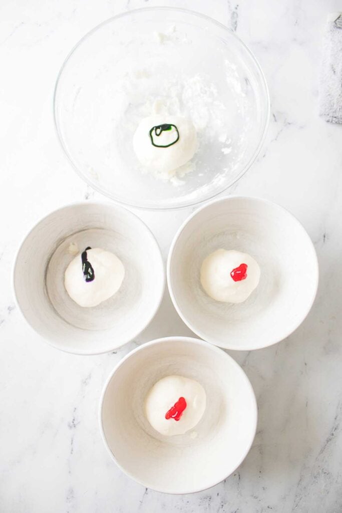 adding food coloring to butter mint dough in bowls