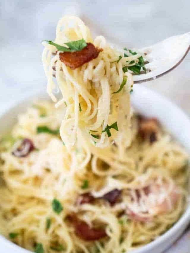 fork holding pasta carbonara