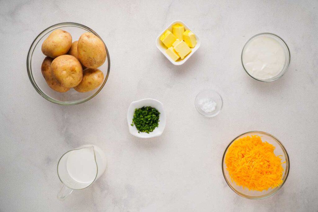 cheesy mashed potato ingredients on marble countertop