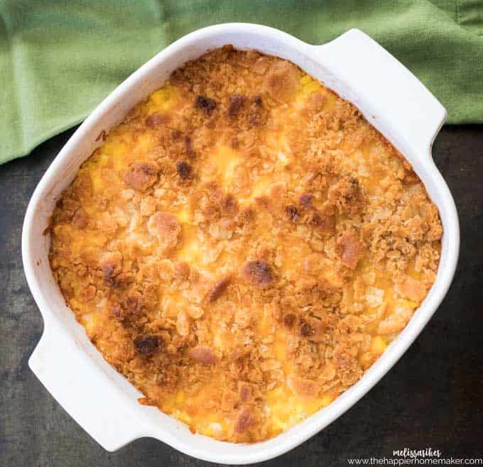 corn pudding in white casserole dish and green napkin