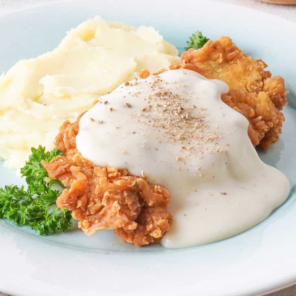 chicken fried steak with white gravy and mashed potatoes