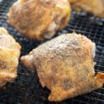 close up of baked chicken thighs on baking sheet