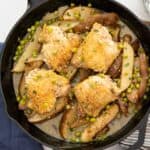 overhead view of cast iron pan with chicken vesuvio