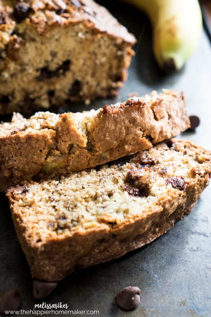 A close up of two slices of chocolate chip banana bread on a table