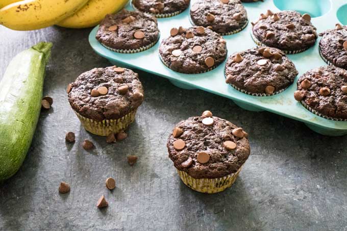 chocolate zucchini muffins in blue silicone baking tray