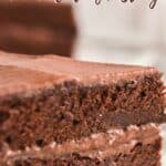 slice of chocolate cake on white plate with text reading homemade chocolate frosting