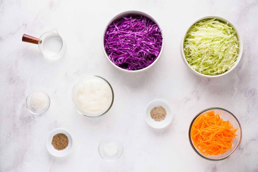 coleslaw ingredients on marble countertop