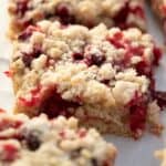 cranberry crumble bars on parchment paper