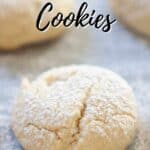 cream cheese cookies with powdered sugar dusting on parchment paper