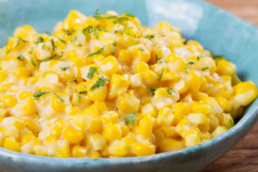 creamed corn in blue bowl