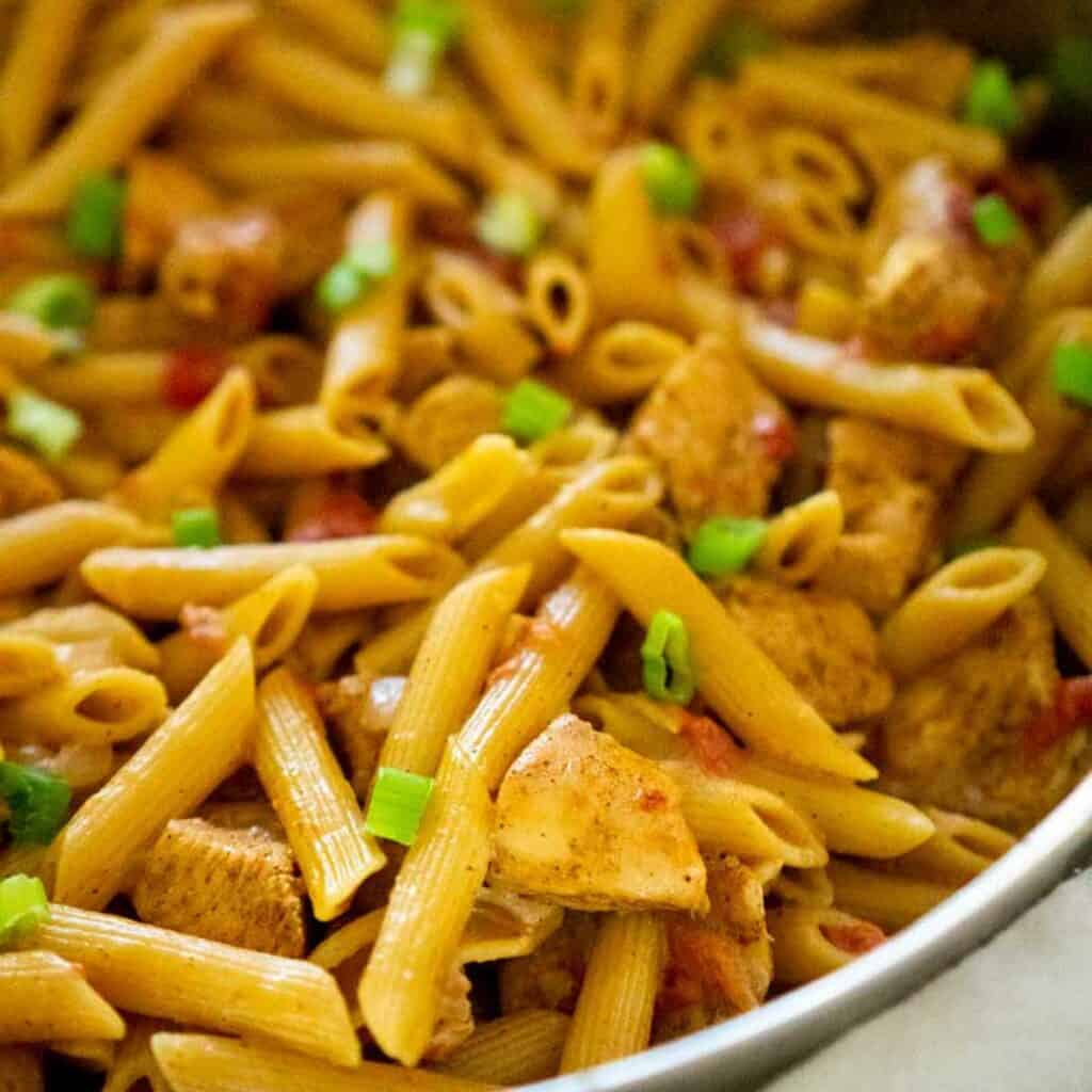 close up of cajun chicken pasta in pan