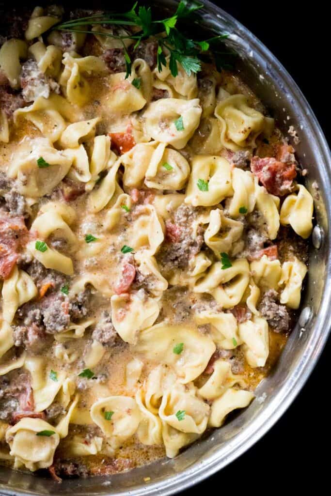 sausage tortellini in large skillet with fresh parsley