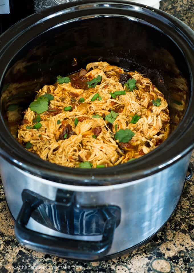 A slow cooker full of Mexican shredded chicken
