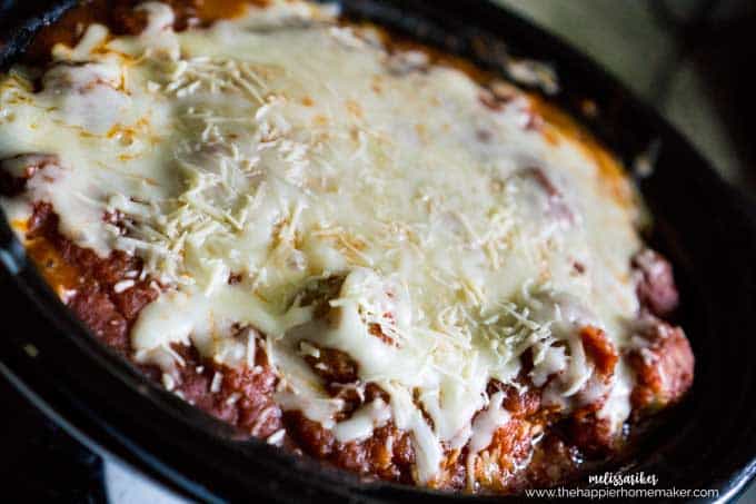 A close up of slow cooker ravioli with meatballs topped with melted cheese