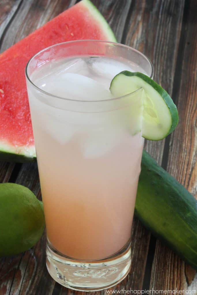 cucumber sunrise cocktail with slice of watermelon in the background