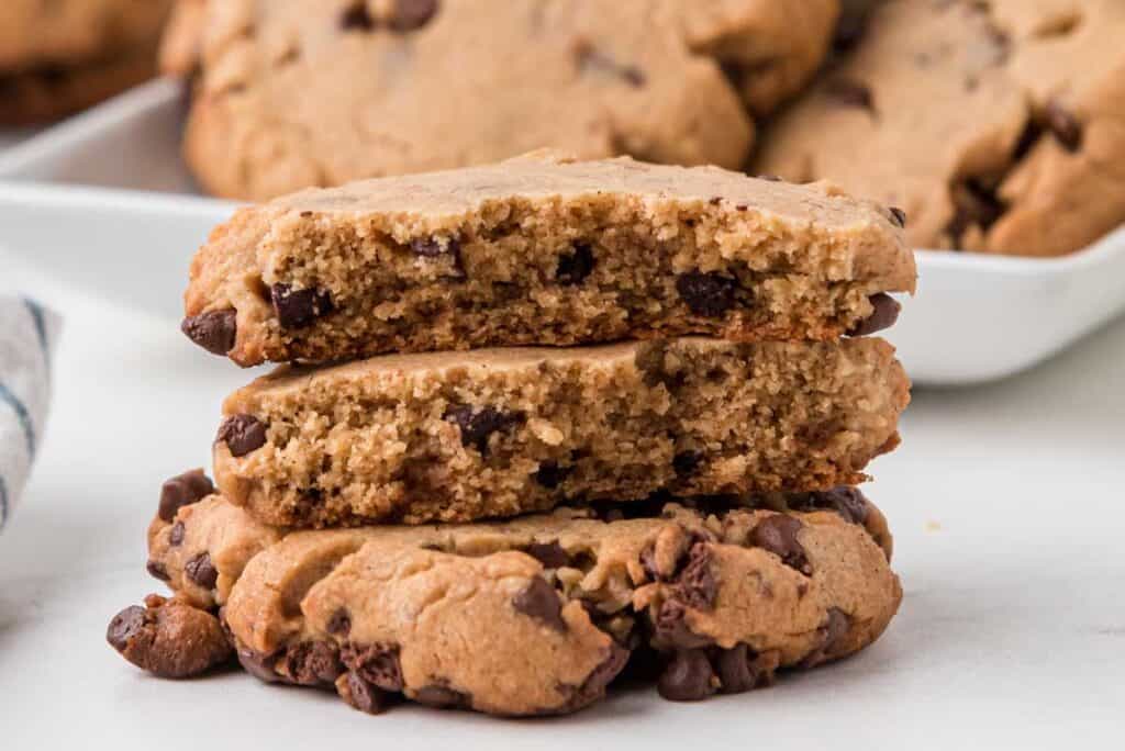 stack of peanut butter chocolate chip cookies with top two broken in half