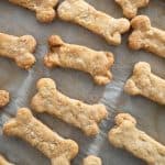 A close up of homemade dog treats sitting on a baking pan