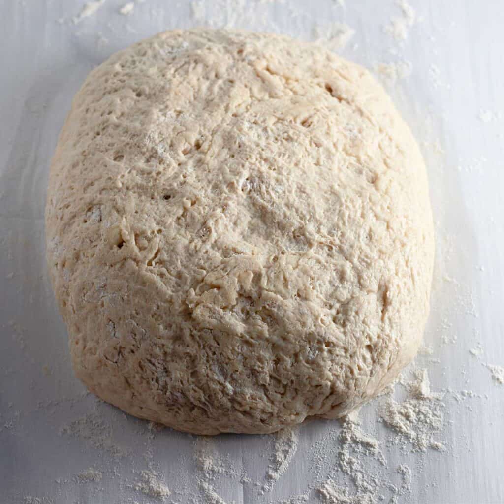 loaf of bread dough on parchment paper