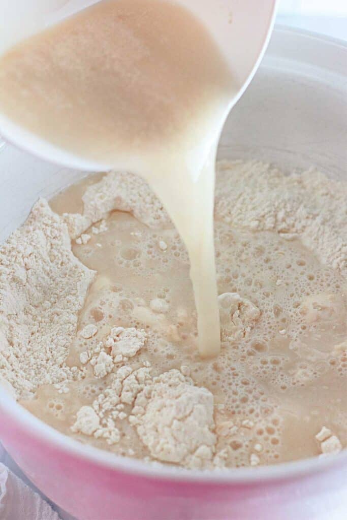 pouring yeast water into flour mixture