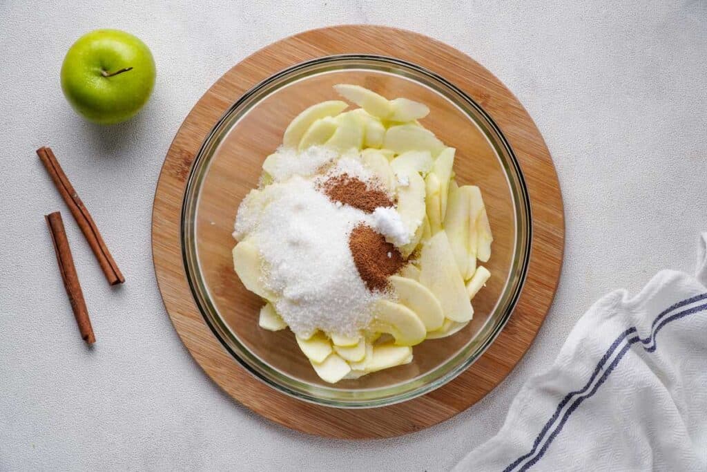 apple pie filling ingredients in glass bowl