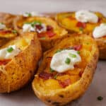 close up of crispy potato skins with sour cream and chives