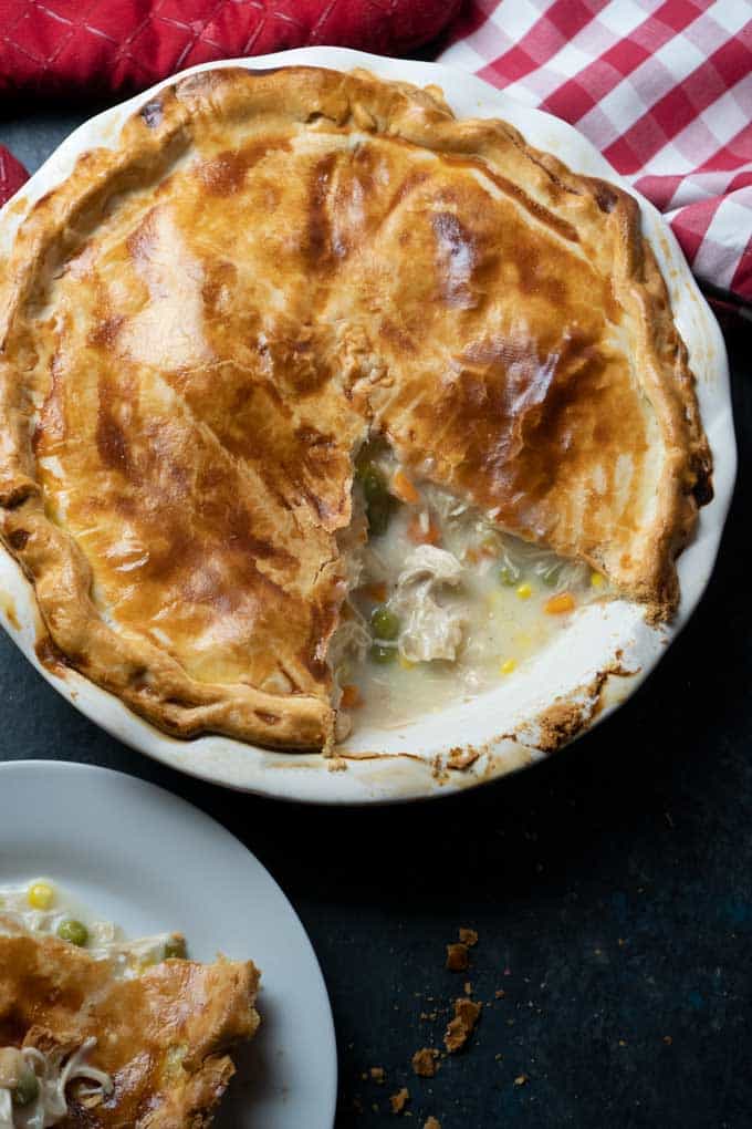 overhead view of homemade chicken pot pie with one slice cut out