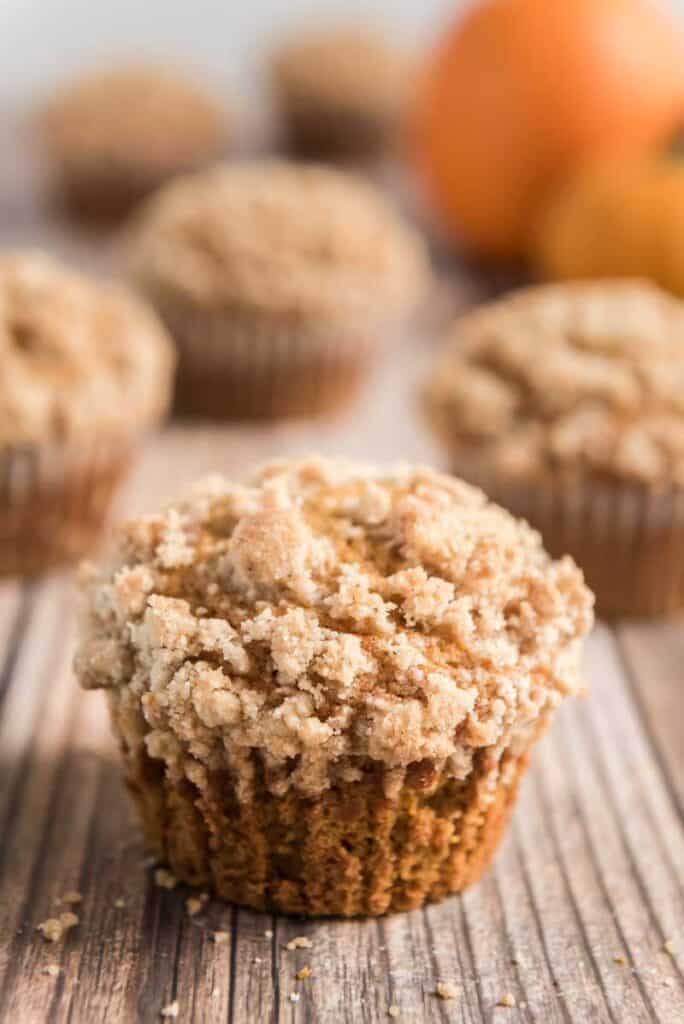 pumpkin muffins with crumble topping on wood board