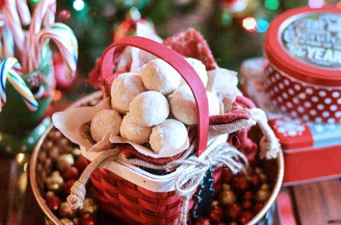 White almond snowball cookies in a red basket