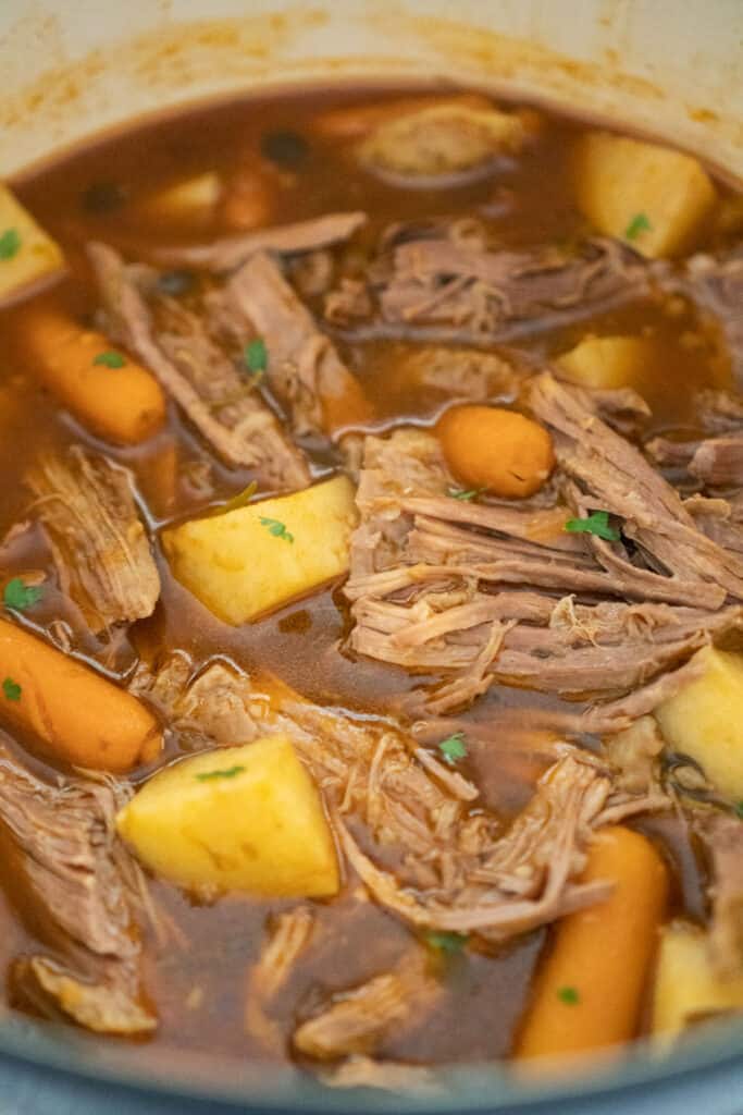 close up of pot roast in a dutch oven