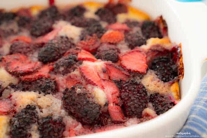 strawberry and blackberry cobbler in white casserole dish