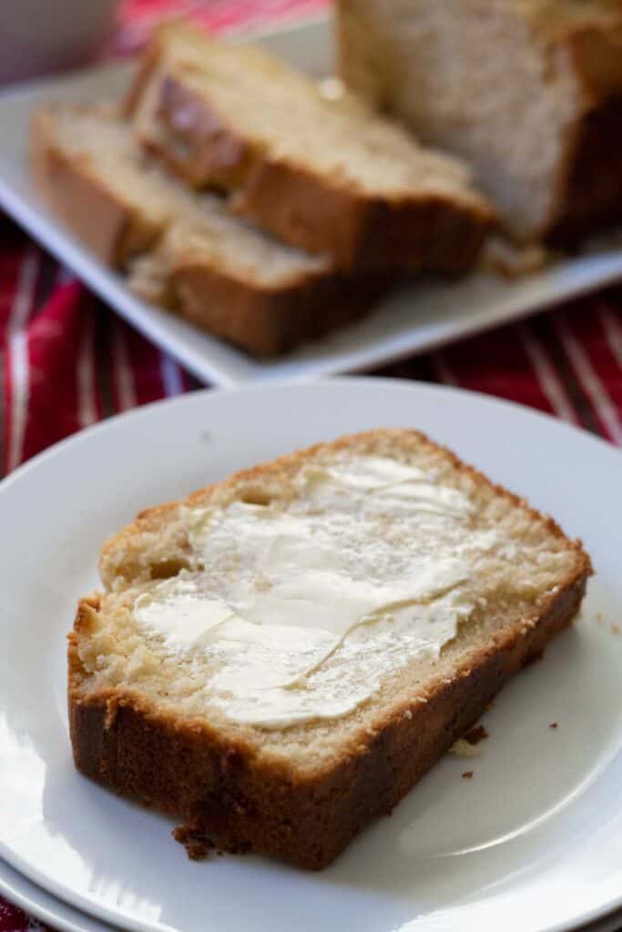 slice of bread with butter on it on white plate