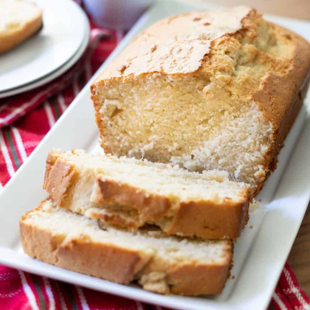 sliced loaf of eggnog bread on white plate