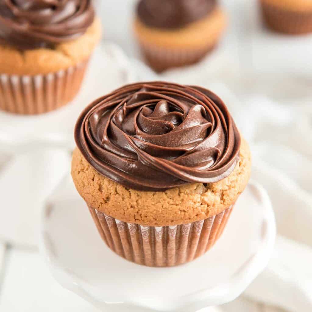 peanut butter cupcake on white pedestal 