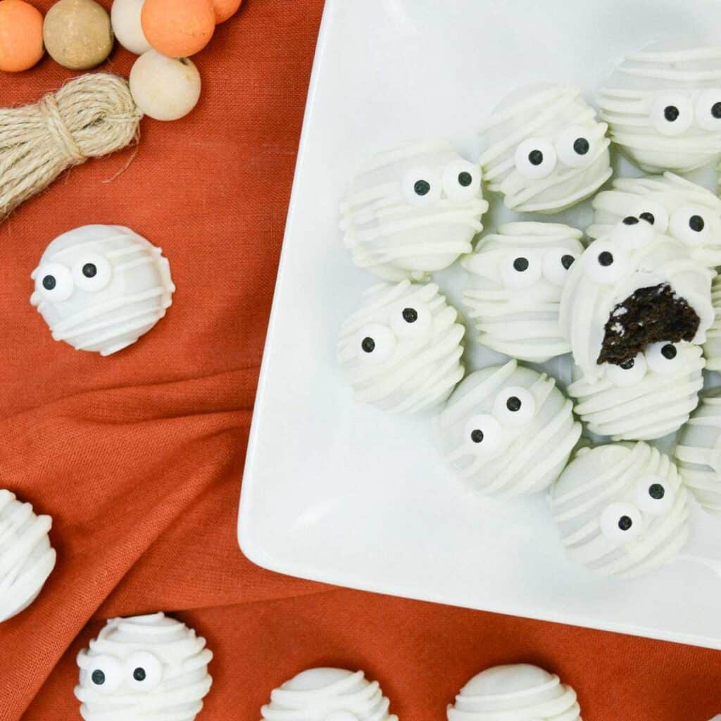 mummy truffles on white plate on orange tablecloth