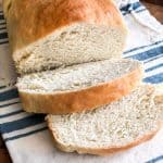 overhead view of loaf of fresh bread with two slices cut