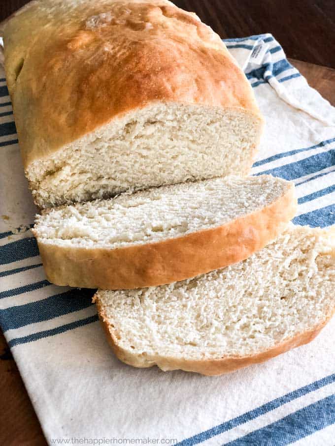 overhead view of loaf of fresh bread with two slices cut