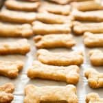 A close up of homemade dog treats on a baking pan