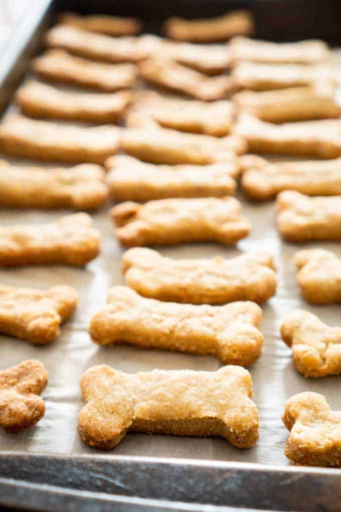 A close up of homemade dog treats on a baking pan