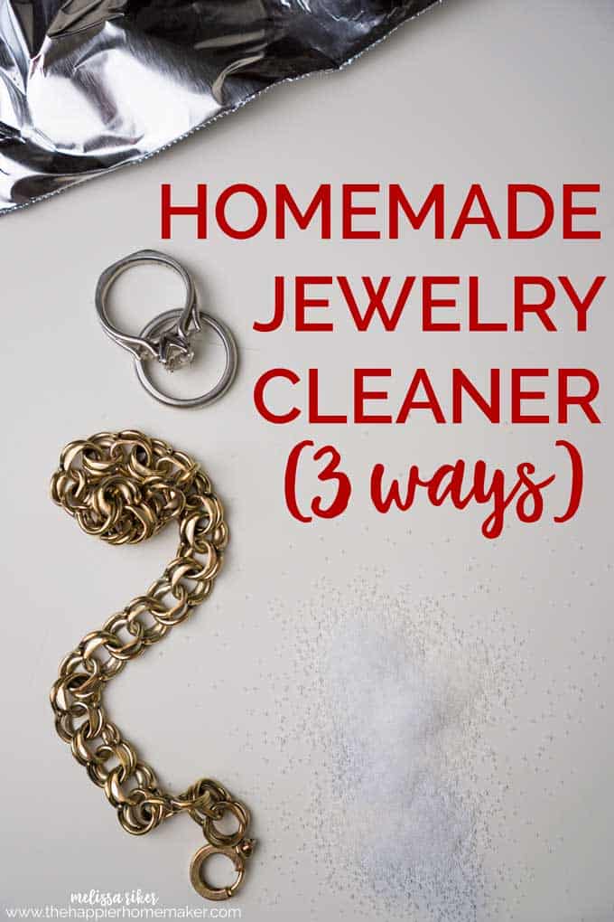 A brass bracelet and platinum wedding rings on white paper with the words \"Homemade Jewelry Cleaner (3 ways)\"