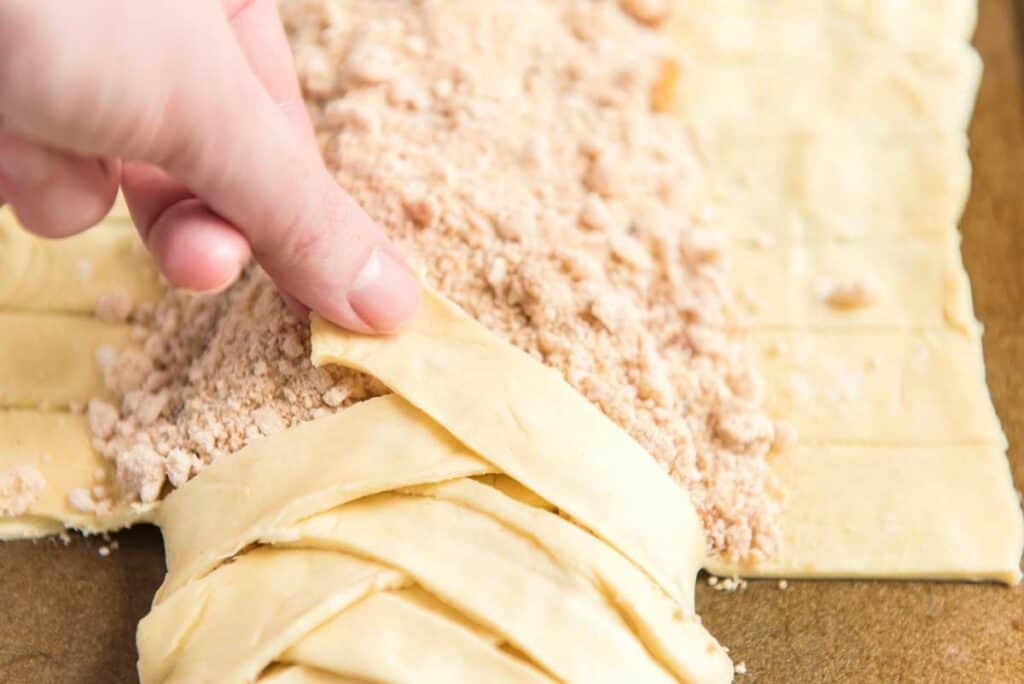 folding pastry dough to make a braided danish