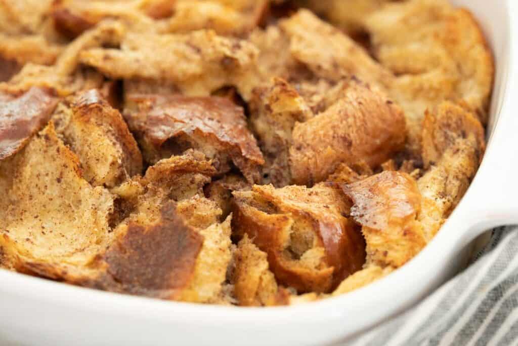 close up of brea pudding in white casserole dish