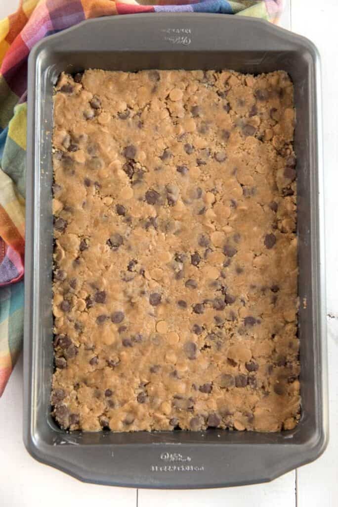 peanut butter chocolate chip cookie bar dough in pan