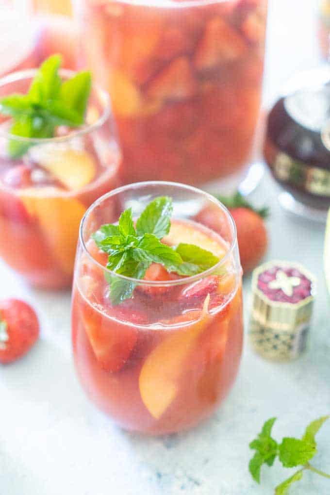 rose sangria with fruit in stemless wine glass