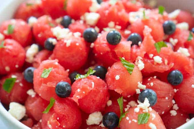 close up of watermelon salad with feta, blueberries, and mint